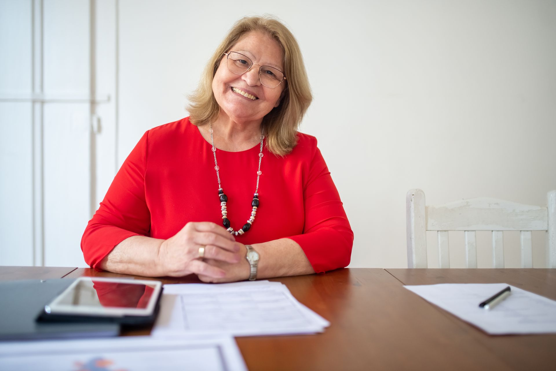 A person works with paper documents at an office desk